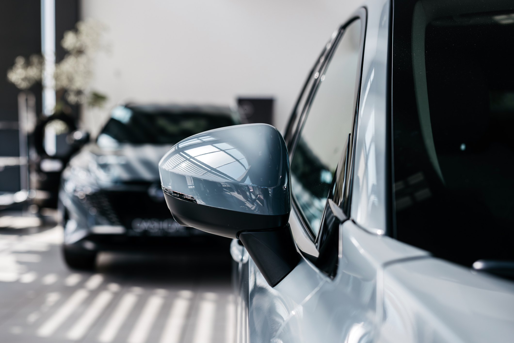 Close-up of new cars in the showroom of the dealership. Concept of buying, leasing, insurance. 