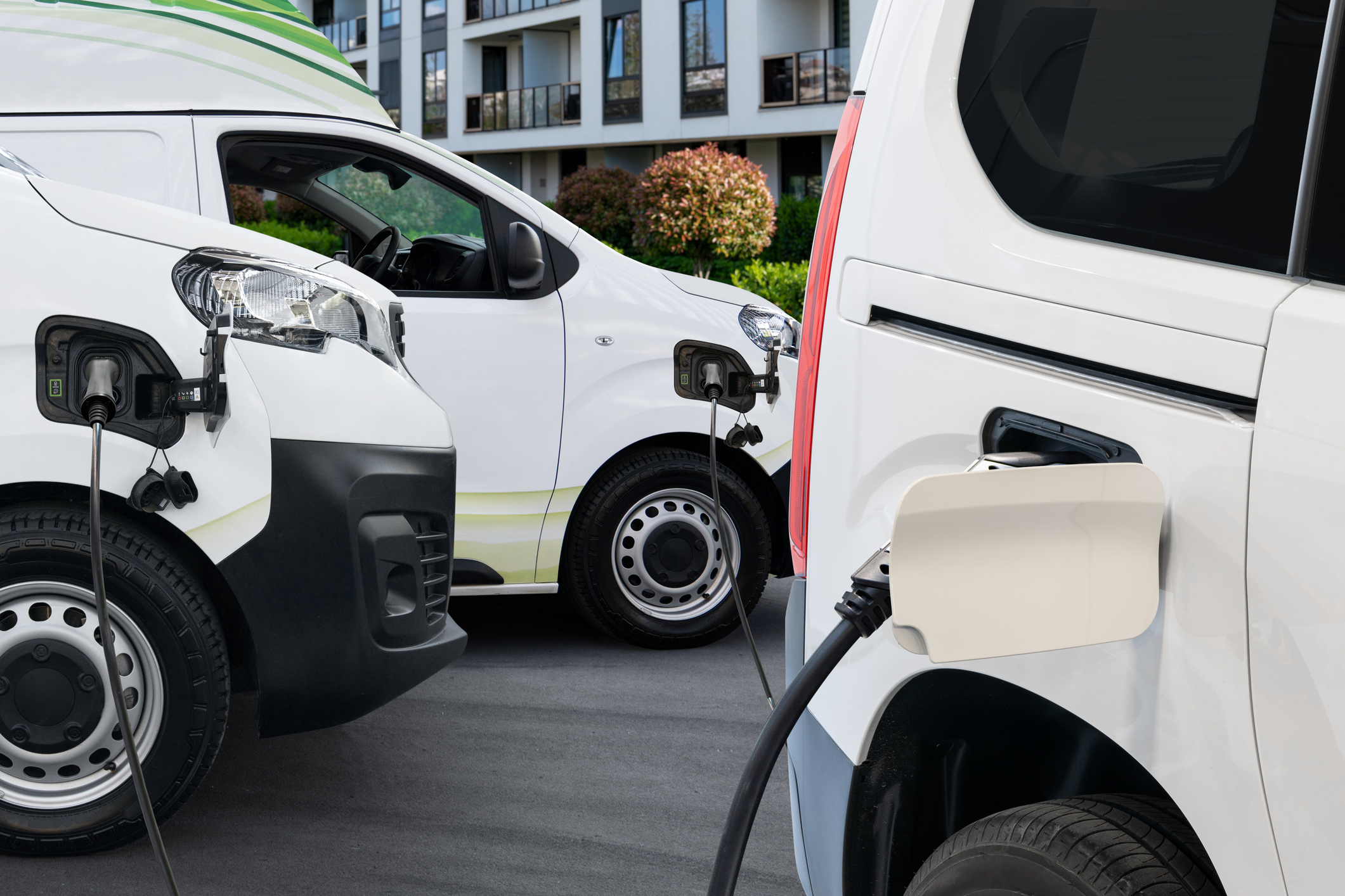 Electric delivery van with connected charging cable.