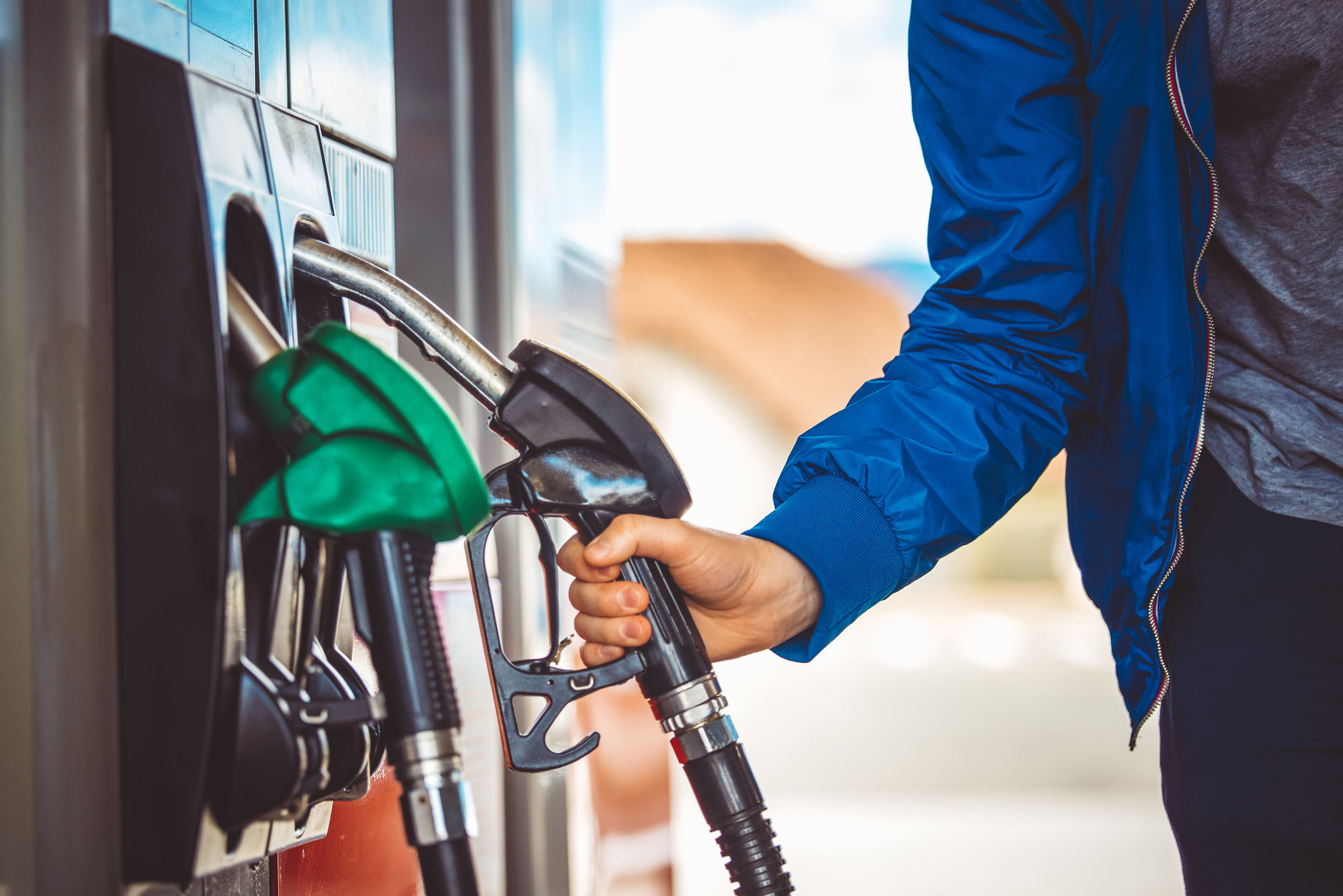 Male hand holding fuel pump nozzle, Diesel Fuel, Car.