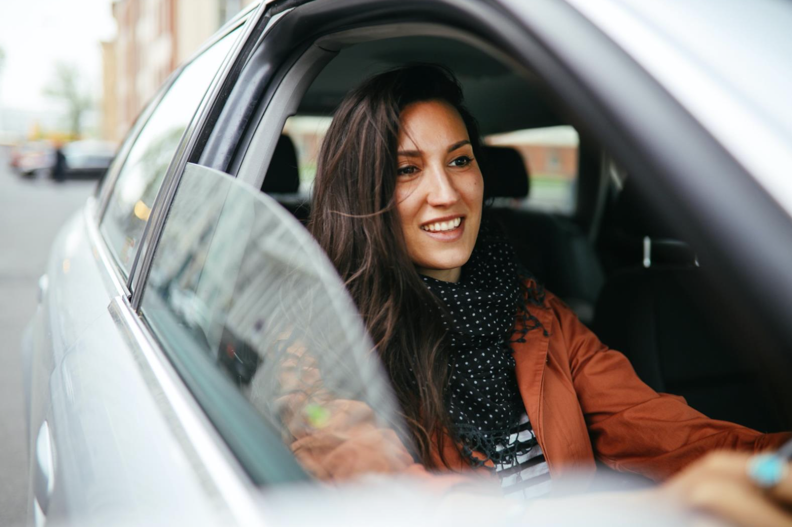 Young commuter woman driving in Berlin Mitte. 