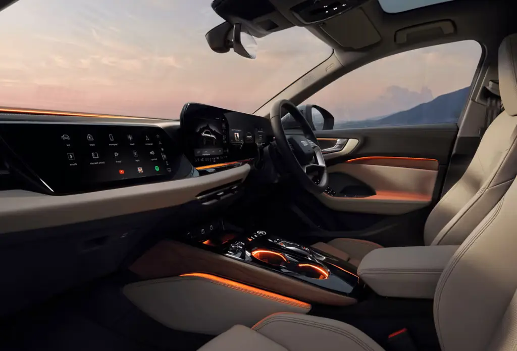 Modern Audi A5 interior featuring ambient lighting, dual digital displays, and beige leather seats at sunset