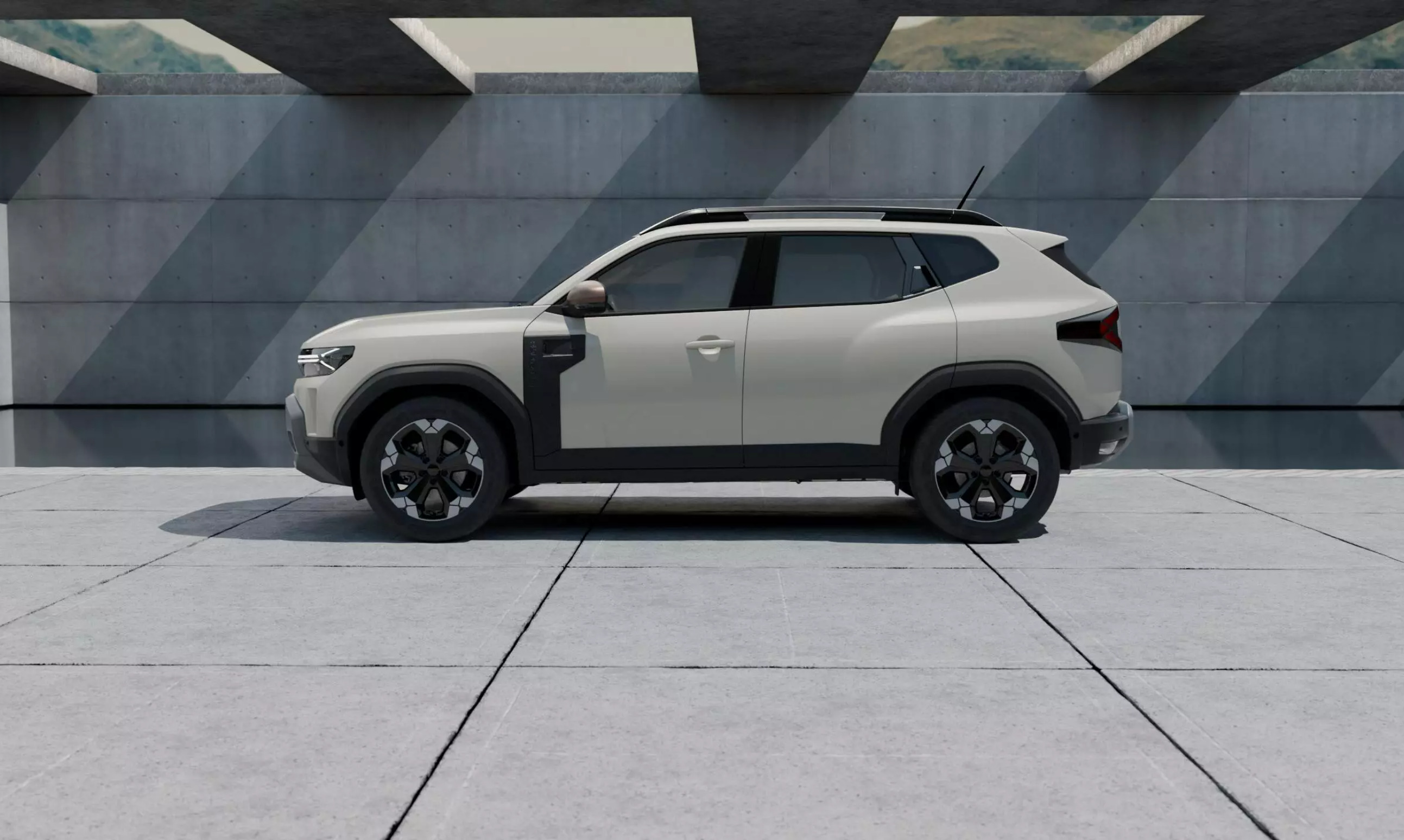 Side view of a Cream Dacia Duster parked in a modern industrial car park