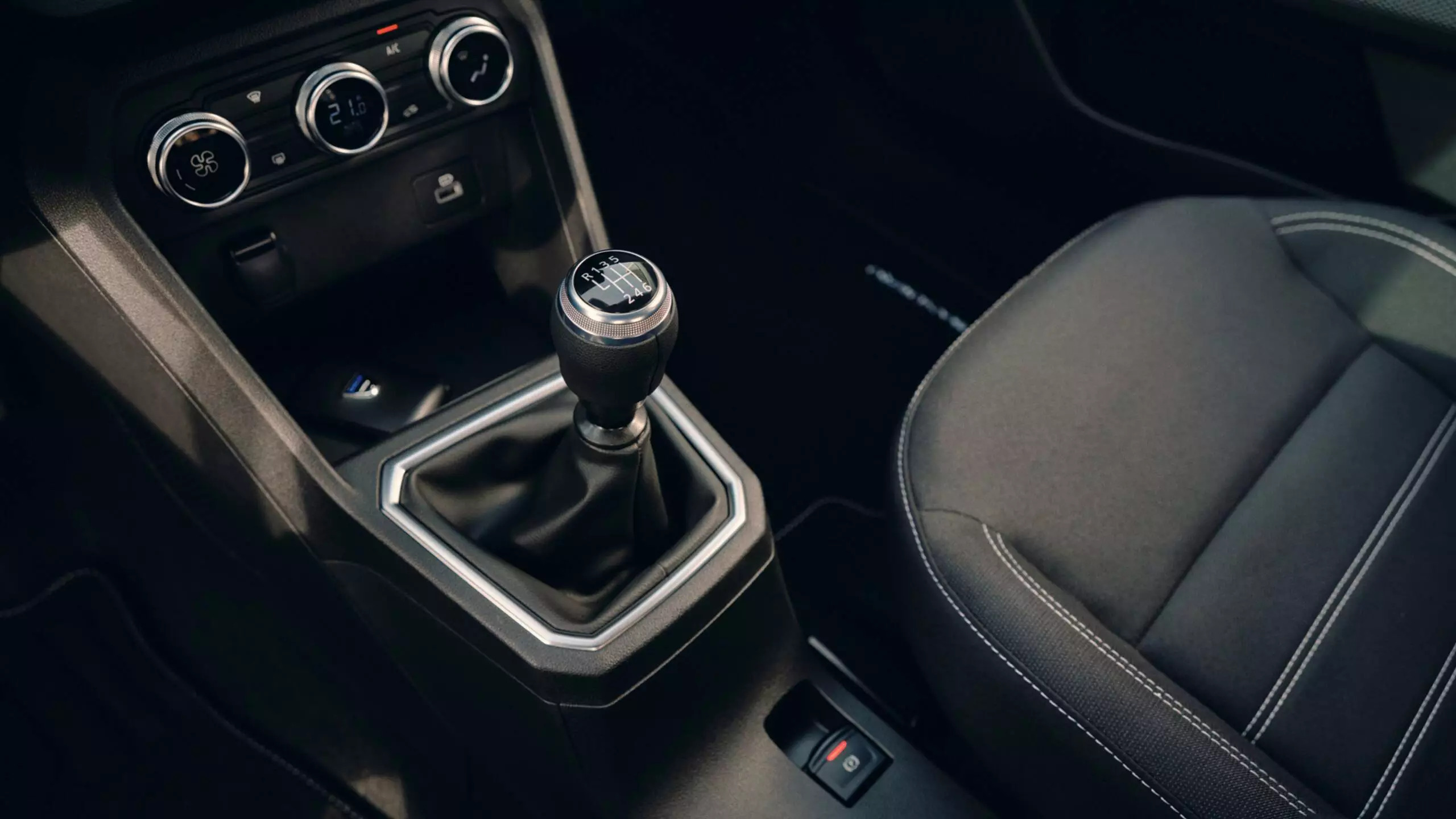 Interior driver’s side of a Dacia Sandero car; smart, clean, dark aesthetic.