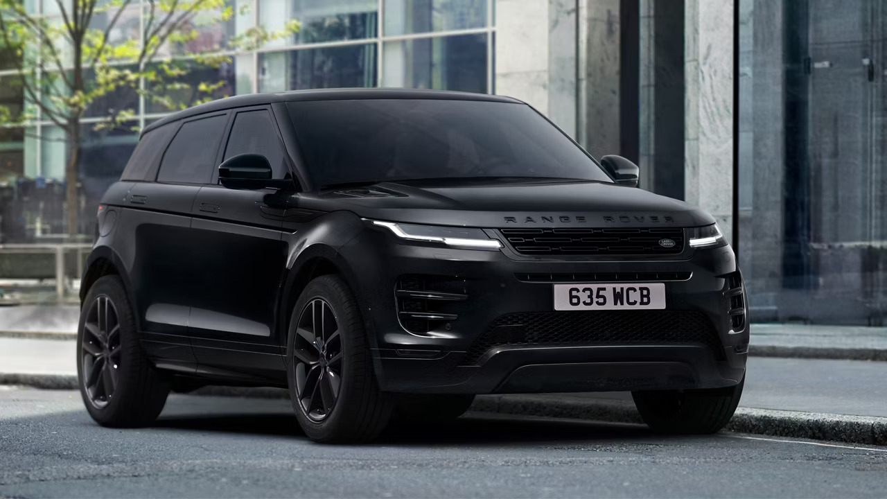 a black Range Rover Evoque parked outside an office building