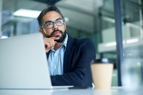 Shot of a mature businessman looking thoughtful while working on a laptop in an office 