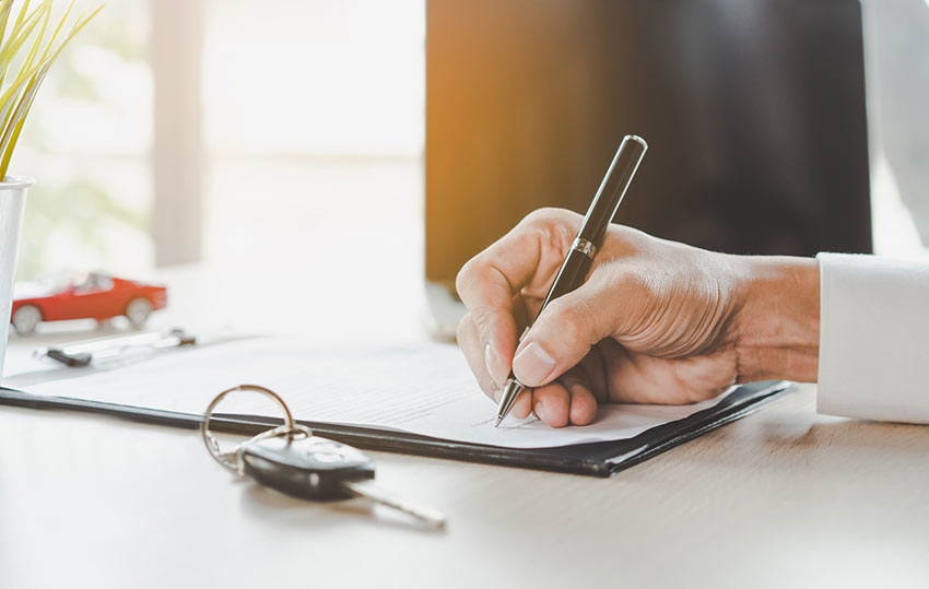 car leasing staff member completing paperwork